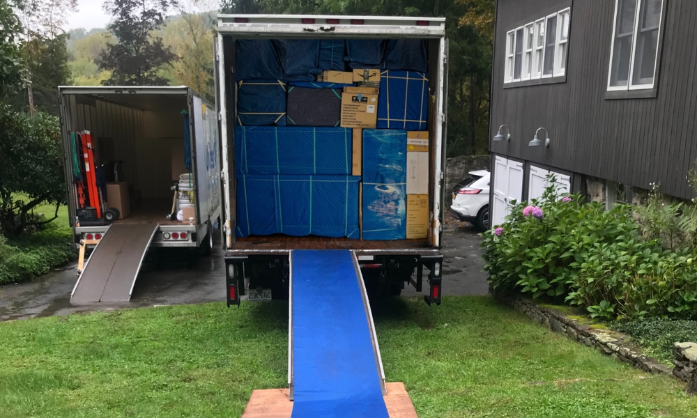 A fully loaded moving truck with its back door open