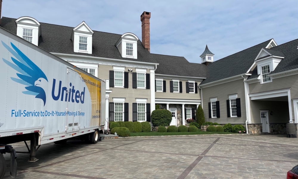 moving truck parked on a paved driveway