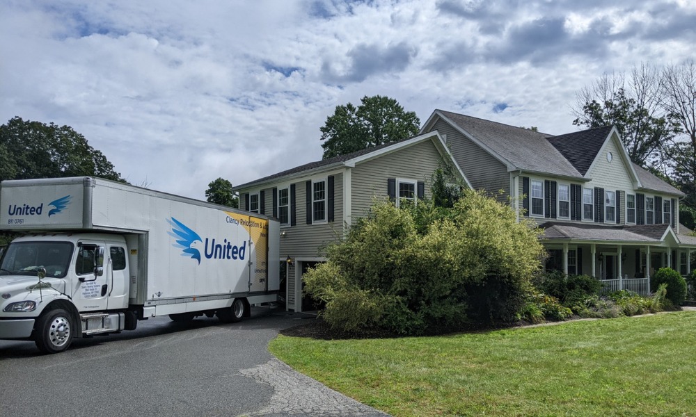 moving truck is parked in the driveway