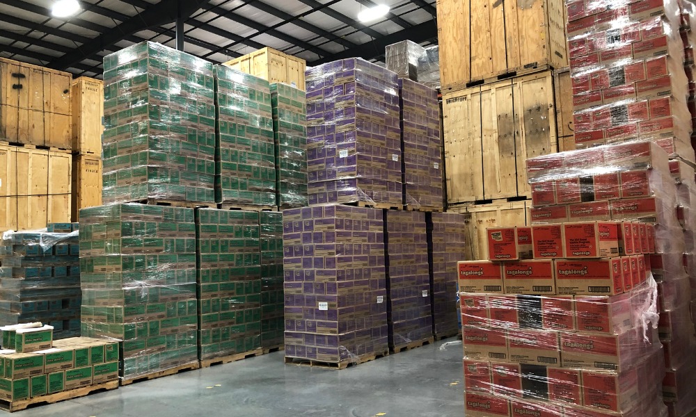 Large warehouse stacks of plastic-wrapped pallets